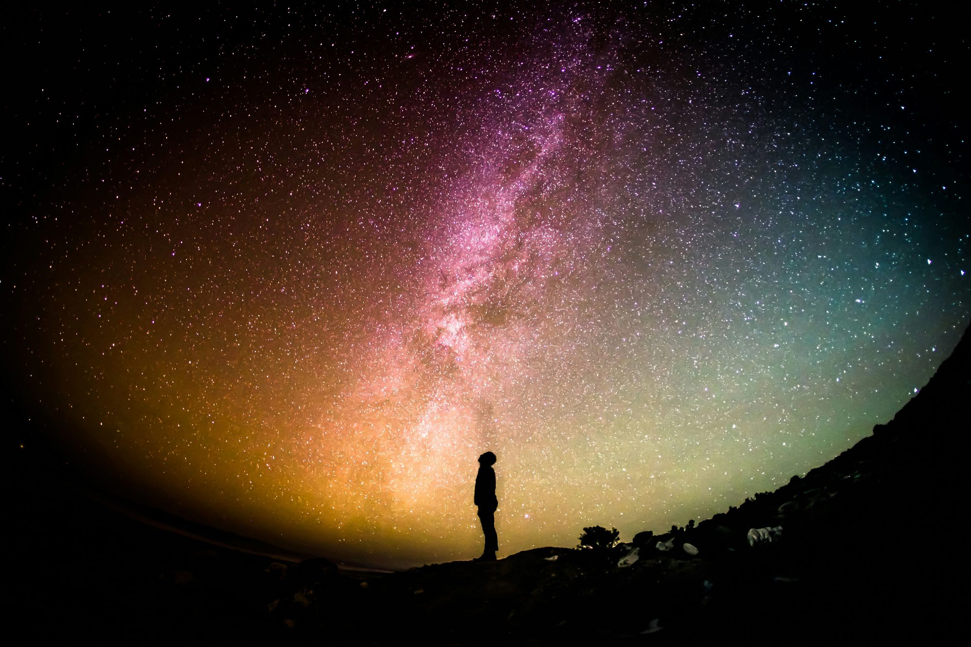 A lone figure beneath the Milky Way